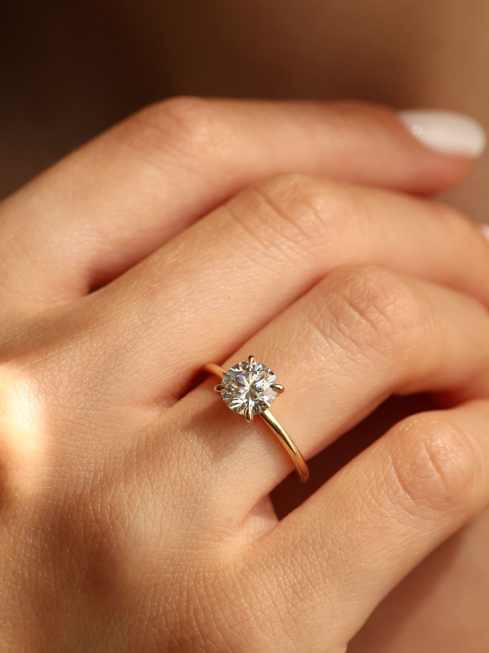 Hand wearing a Di Monti Classic engagement ring